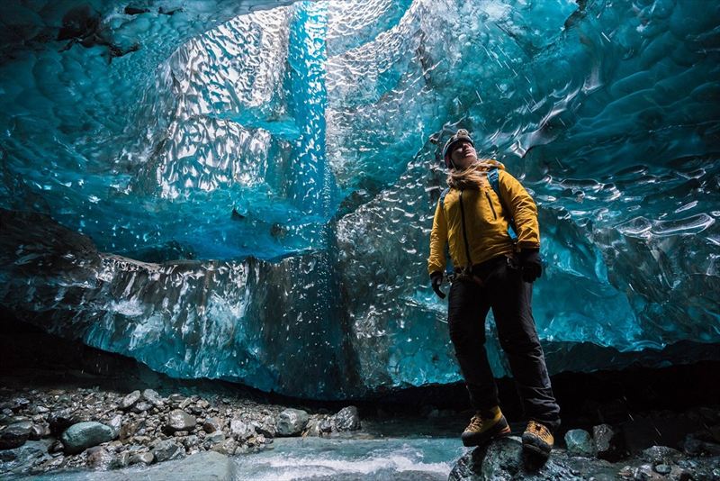 Wednesday 25th November 2015, Vatnajökull national park, Iceland: Photographer Mikael Buck with assistance from renowned local Icelandic guide Einar Runar Sigurdsson, explored the frozen world of Vatnajökull glacier in Iceland using Sony’s world first back-illuminated full-frame sensor – which features in the α7R II camera. His images were taken without use of a tripod or any image stitching techniques in photoshop. This was made possible through Sony’s new sensor technology, allowing incredibly detailed low-light hand held photography. Previously images this detailed would have required carrying bulky equipment to the caves, some of which can require hiking and climbing over a glacier for up to two hours to to access. This picture: Guide Helen Maria is pictured inside the waterfall cave PR Handout - editorial usage only. Photographer's details not to be removed from metadata or byline. For further information please contact Rochelle Collison at Hope & Glory PR on 020 7014 5306 or rochelle.collison@hopeandglorypr.com Copyright: © Mikael Buck / Sony 07828 201 042 / mikaelbuck@gmail.com