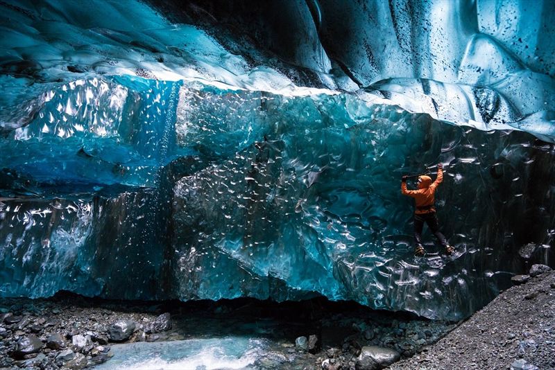 Wednesday 25th November 2015, Vatnajökull national park, Iceland: Photographer Mikael Buck with assistance from renowned local Icelandic guide Einar Runar Sigurdsson, explored the frozen world of Vatnajökull glacier in Iceland using Sony’s world first back-illuminated full-frame sensor – which features in the α7R II camera. His images were taken without use of a tripod or any image stitching techniques in photoshop. This was made possible through Sony’s new sensor technology, allowing incredibly detailed low-light hand held photography. Previously images this detailed would have required carrying bulky equipment to the caves, some of which can require hiking and climbing over a glacier for up to two hours to to access. This picture: Guide Einar Runar Sigurdsson is seen ice climbing inside the 'Waterfall Cave' PR Handout - editorial usage only. Photographer's details not to be removed from metadata or byline. For further information please contact Rochelle Collison at Hope & Glory PR on 020 7014 5306 or rochelle.collison@hopeandglorypr.com Copyright: © Mikael Buck / Sony 07828 201 042 / mikaelbuck@gmail.com