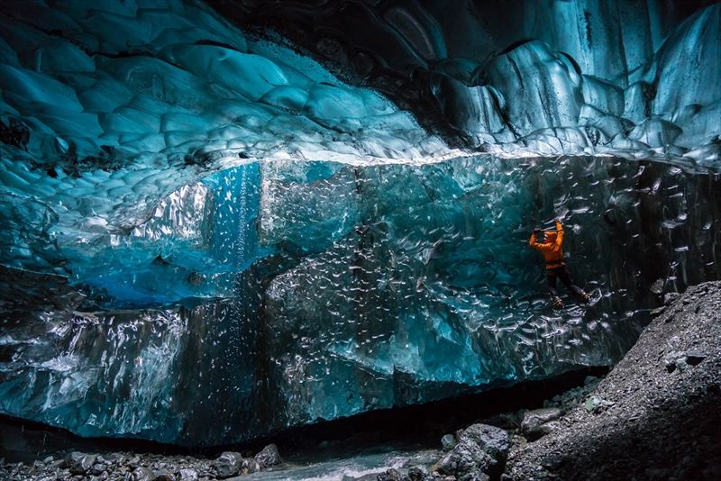 Wednesday 25th November 2015, Vatnajökull national park, Iceland: Photographer Mikael Buck with assistance from renowned local Icelandic guide Einar Runar Sigurdsson, explored the frozen world of Vatnajökull glacier in Iceland using Sony’s world first back-illuminated full-frame sensor – which features in the α7R II camera. His images were taken without use of a tripod or any image stitching techniques in photoshop. This was made possible through Sony’s new sensor technology, allowing incredibly detailed low-light hand held photography. Previously images this detailed would have required carrying bulky equipment to the caves, some of which can require hiking and climbing over a glacier for up to two hours to to access. This picture: Guide Einar Runar Sigurdsson is seen ice climbing inside the 'Waterfall Cave' PR Handout - editorial usage only. Photographer's details not to be removed from metadata or byline. For further information please contact Rochelle Collison at Hope & Glory PR on 020 7014 5306 or rochelle.collison@hopeandglorypr.com Copyright: © Mikael Buck / Sony 07828 201 042 / mikaelbuck@gmail.com