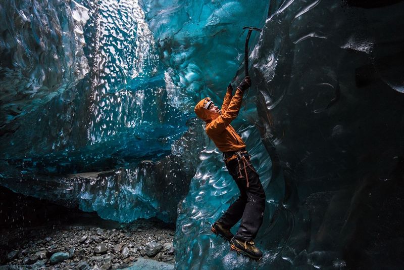 Wednesday 25th November 2015, Vatnajökull national park, Iceland: Photographer Mikael Buck with assistance from renowned local Icelandic guide Einar Runar Sigurdsson, explored the frozen world of Vatnajökull glacier in Iceland using Sony’s world first back-illuminated full-frame sensor – which features in the α7R II camera. His images were taken without use of a tripod or any image stitching techniques in photoshop. This was made possible through Sony’s new sensor technology, allowing incredibly detailed low-light hand held photography. Previously images this detailed would have required carrying bulky equipment to the caves, some of which can require hiking and climbing over a glacier for up to two hours to to access. This picture: Guide Einar Runar Sigurdsson is seen ice climbing inside the 'Waterfall Cave' PR Handout - editorial usage only. Photographer's details not to be removed from metadata or byline. For further information please contact Rochelle Collison at Hope & Glory PR on 020 7014 5306 or rochelle.collison@hopeandglorypr.com Copyright: © Mikael Buck / Sony 07828 201 042 / mikaelbuck@gmail.com